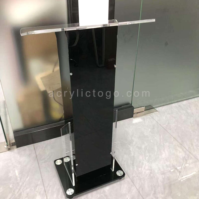 Black acrylic lectern with transparent side panels and stainless steel feet, modern style