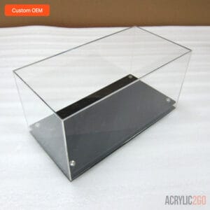 Empty custom acrylic display case with black base and stainless metal feet — angled view showing clear cover and black platform, OEM bulk manufacturer