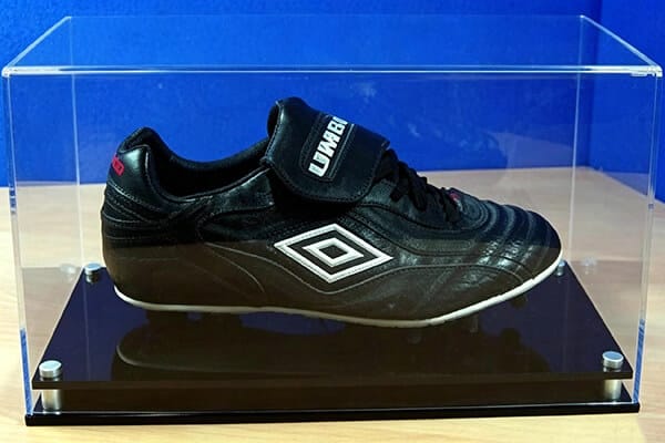 Umbro football boot in premium custom acrylic shoe display case with black base and metal feet — 500-unit OEM order for German football club memorabilia