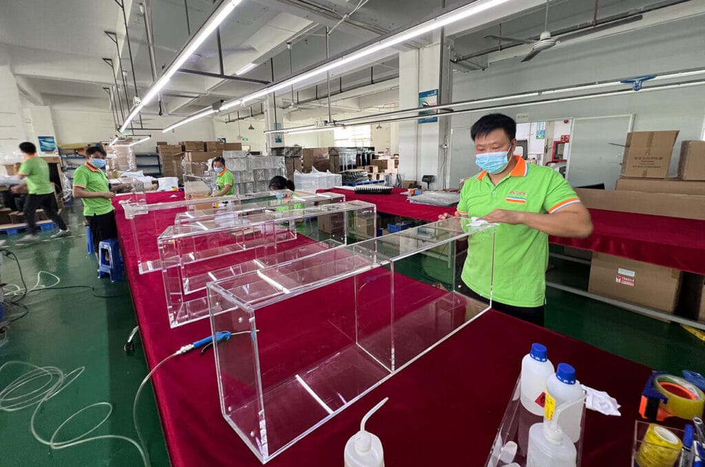 Skilled technician cleaning high-Custom acrylic lecterns and podiums manufacturing process in Shenzhen factory