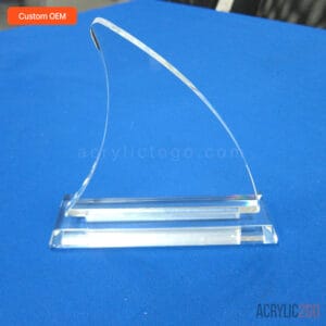 Clear curved wave acrylic trophy with hand-polished CNC-routed blade on a rectangular base, front view