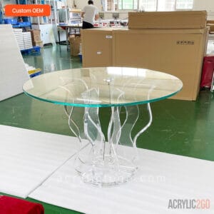 Front view of custom acrylic wave-base dining table with clear glass top for hospitality and residential use