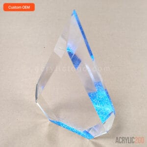 Faceted crystal acrylic trophy shown at an angle, highlighting the cut facets and blue gradient base