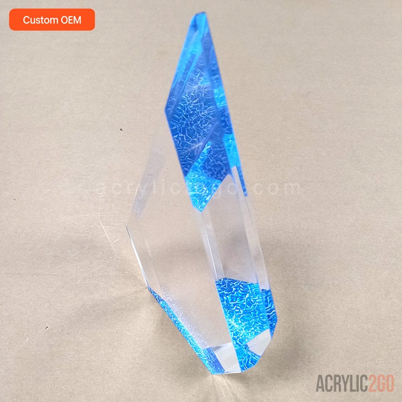 Faceted crystal acrylic trophy rotated to show the asymmetric cut facets along one edge