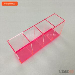 Angled view of acrylic compartment tray showing the zigzag top profile of the triangular dividers