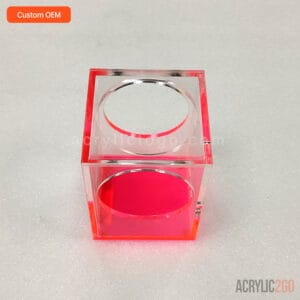 Front view of acrylic pen holder showing overlapping circular window cutouts on adjacent faces