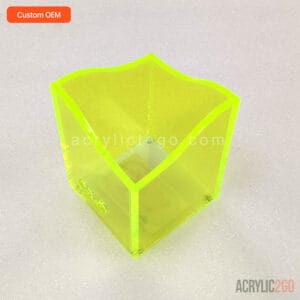Fluorescent yellow-green acrylic pen organizer with a wavy, undulating rim, front angled view