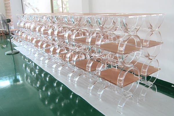 Rows of acrylic benches in mass production, showing factory-scale output for wholesale and bulk orders