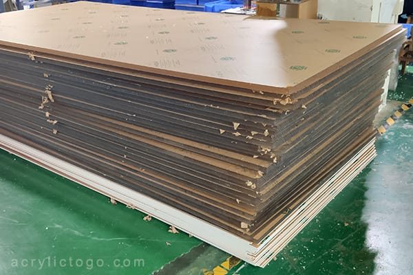 Stack of raw cast acrylic sheets used to manufacture custom acrylic trophies and awards